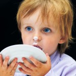 Little Boy Licking his Plate